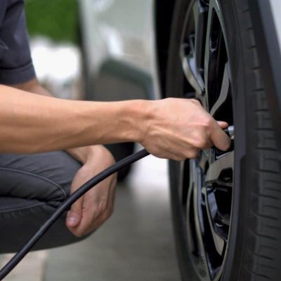 man-filling-air-in-the-tires-of-his-car-inflating-tire-1024x683